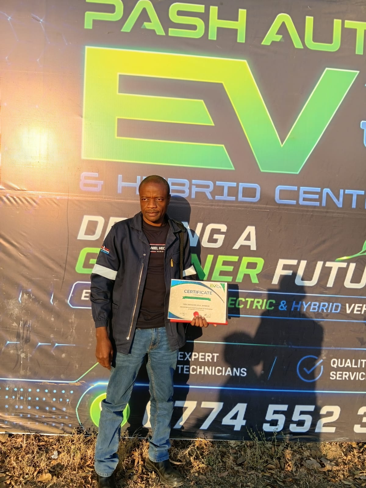 Technician holding an EV and hybrid training certificate