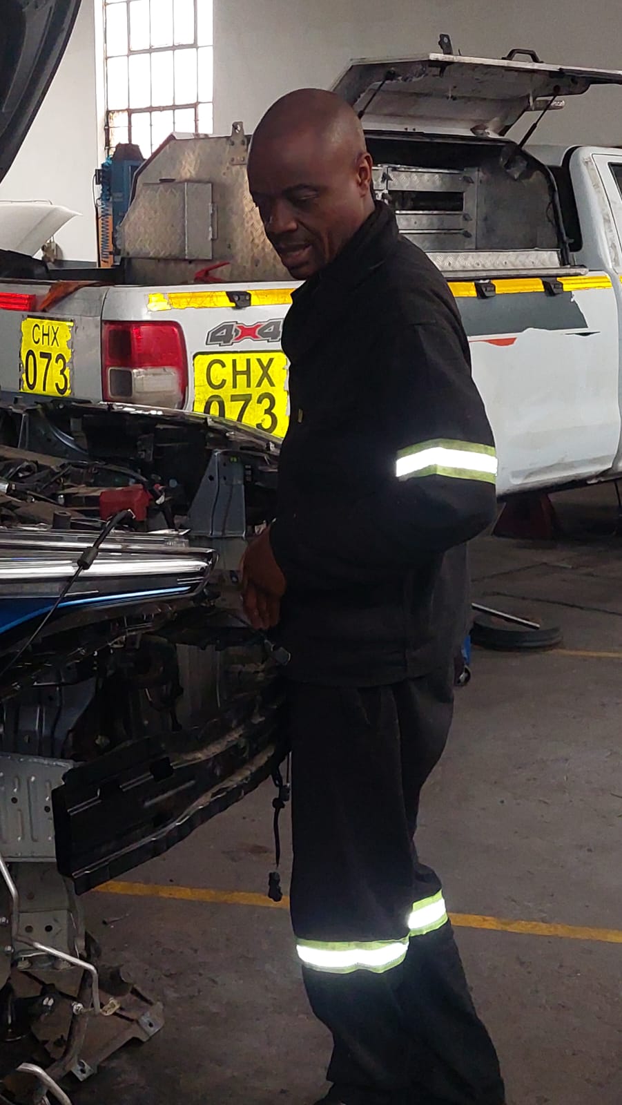Technician working on a stripped front end in the workshop