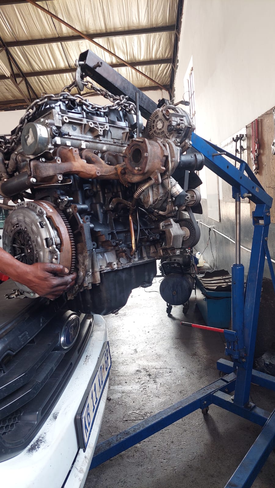 Engine and clutch assembly lifted out with an engine crane