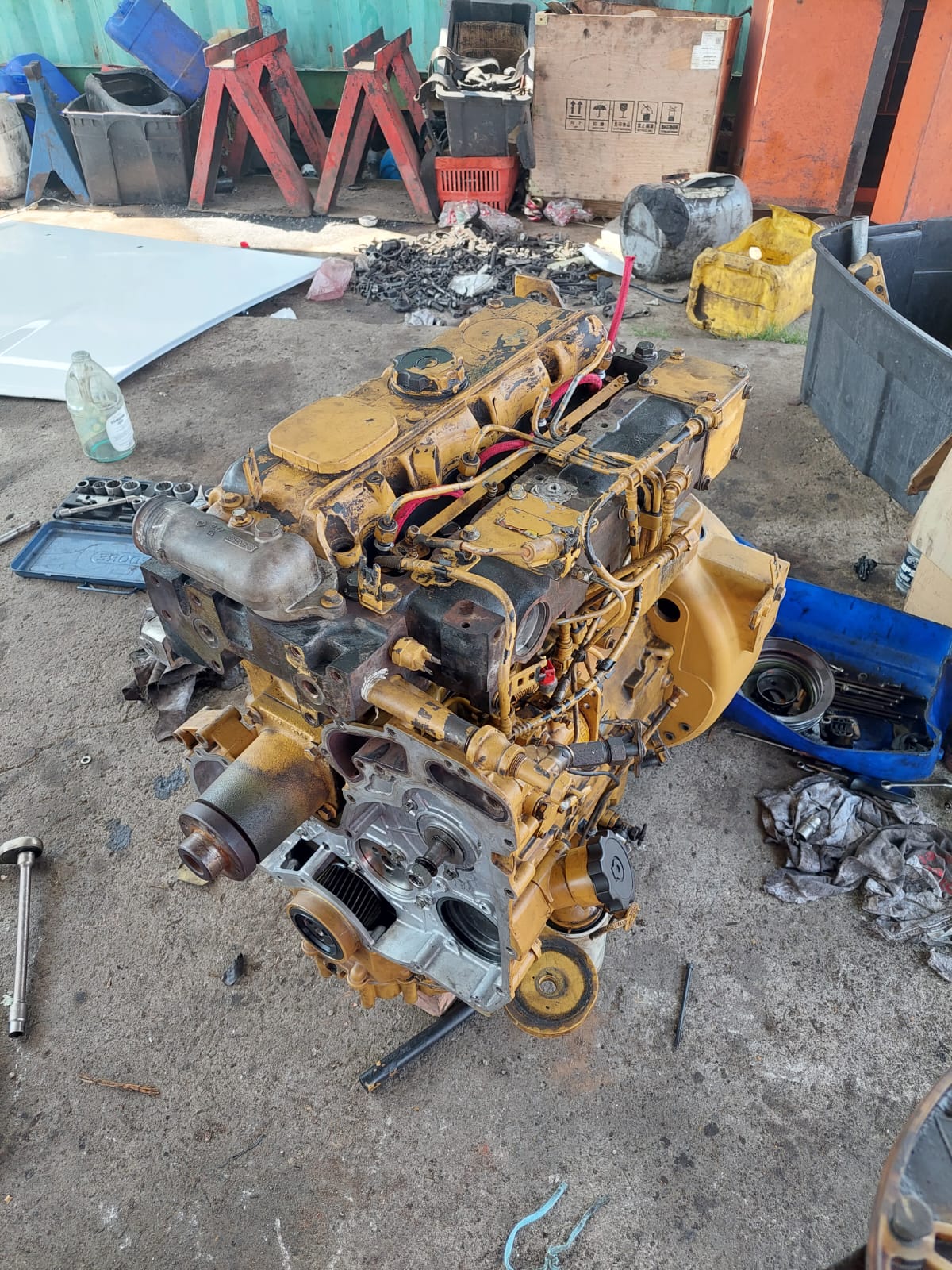 Stripped engine block on the workshop floor during an overhaul