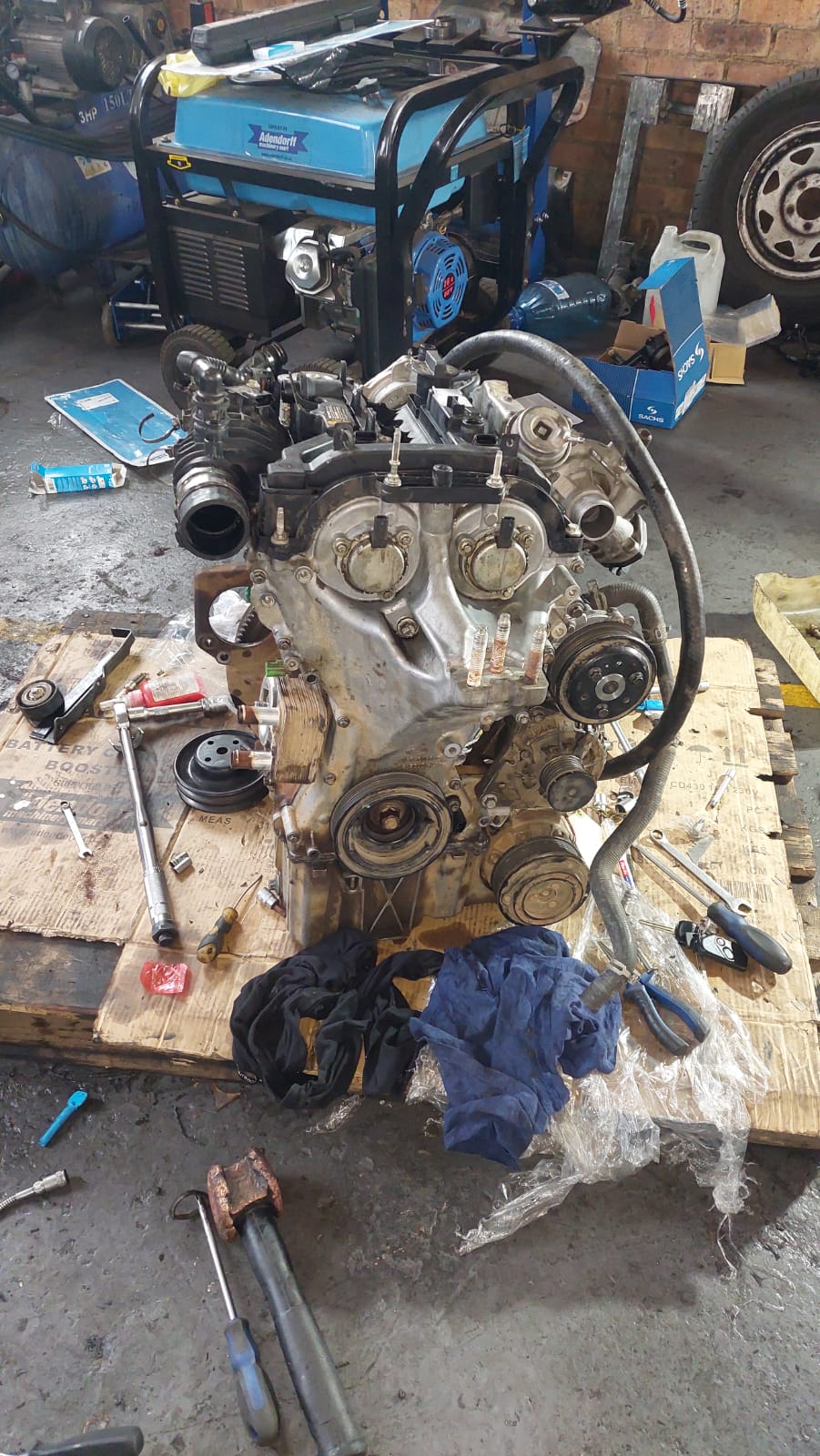 Engine stripped down on the bench with tools laid out