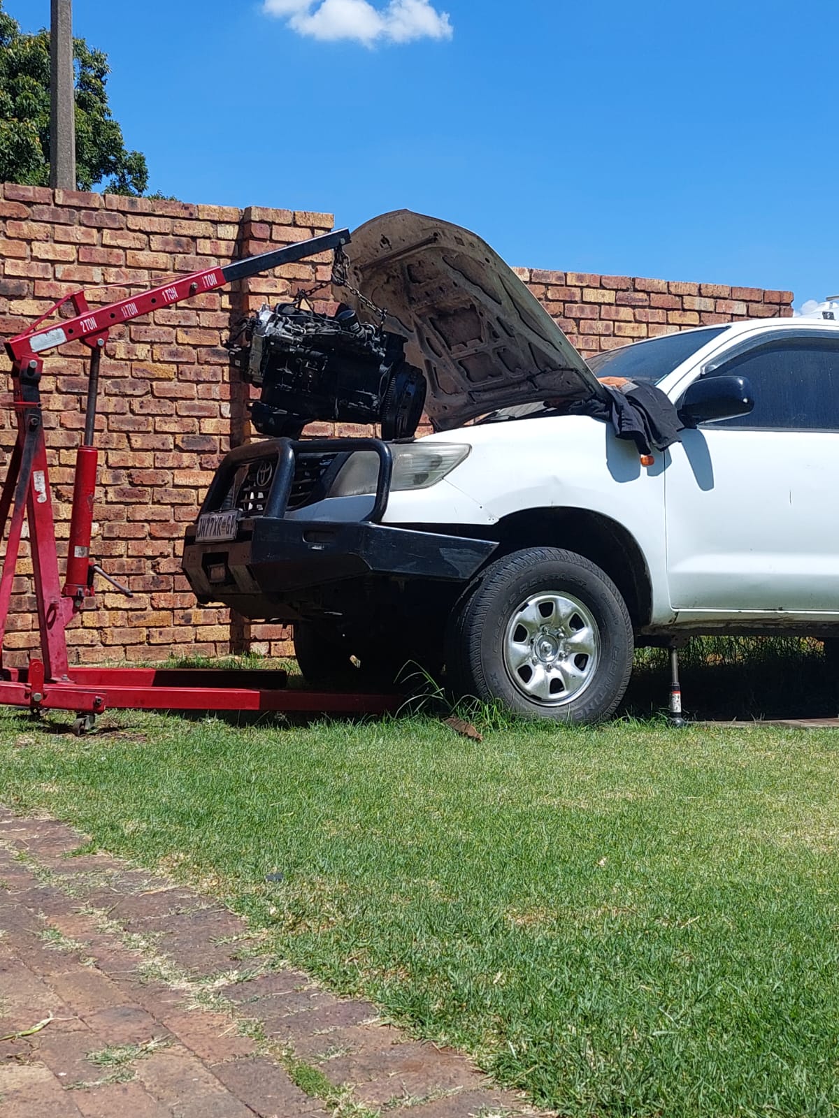 Engine lifted out of a Toyota Hilux with an engine crane